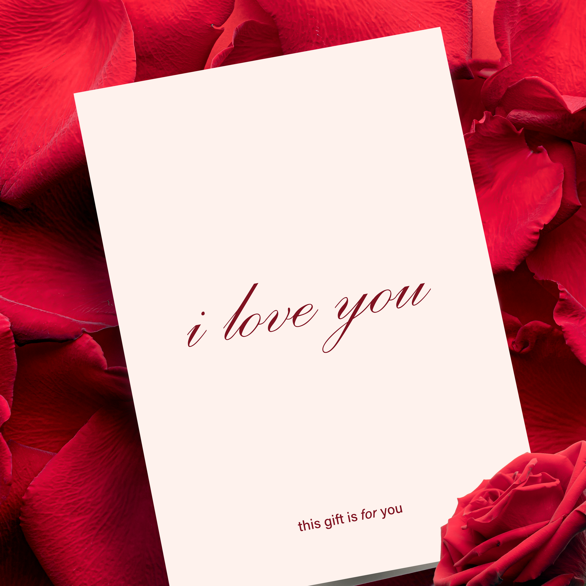 Minimalistic Greeting Card with 'i love you' text on red rose petals