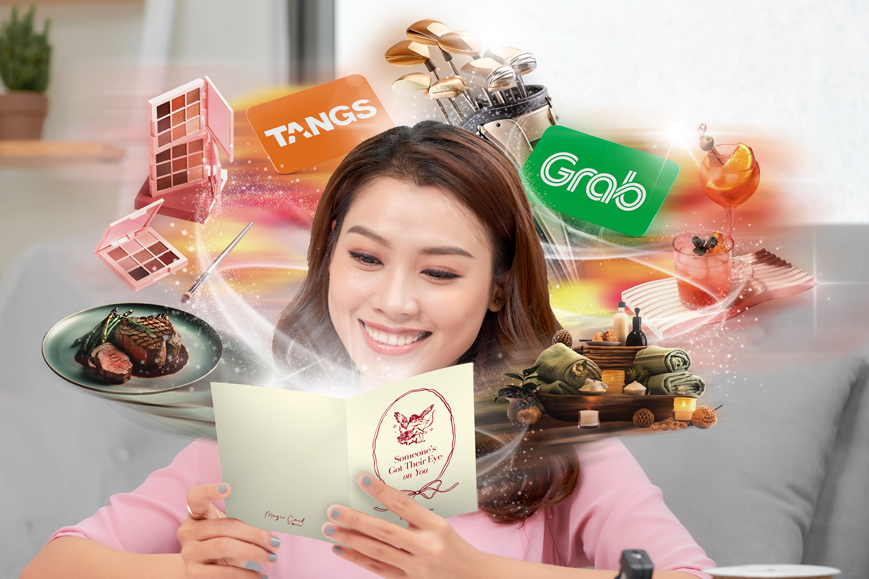 Woman holding Valentine's Day Greeting Card with Gifts Like Spas, Dining, GRAB Gift Cards and More