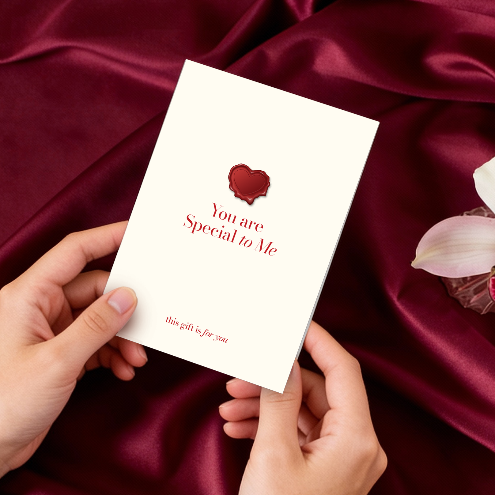 Hands holding a card with 'You are Special to Me' message on a red satin background